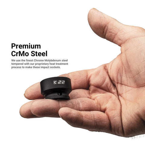 Hand holding single 22mm stubby impact socket with CrMo steel for Stubby One Half Inch Drive Impact Socket Set For Metric Ten To Twenty Four Millimeter Fifteen Piece Twenty Percent Shorter For Tight Spots Premium Chrome Molybdenum Steel Heat Treated With Manganese Phosphate Coating For Torque And Lasting Durability.