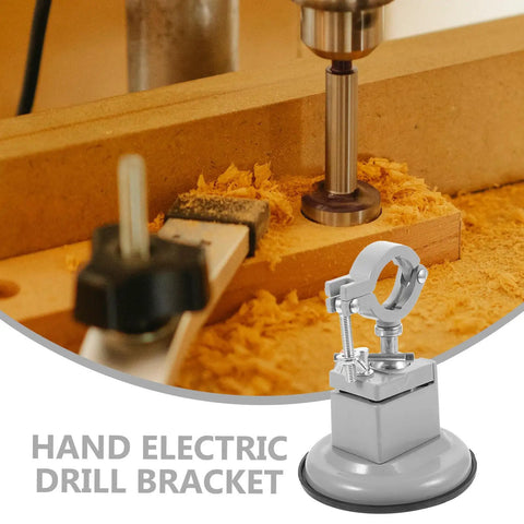 Hand electric drill bracket on wooden workbench with sawdust, close-up of clamping mechanism for precise drilling.