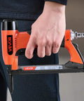 Pro Grade 20 Gauge Pneumatic Staple Gun Featuring A Slick Long Nose, being held in hand, ideal for upholstery and DIY projects.