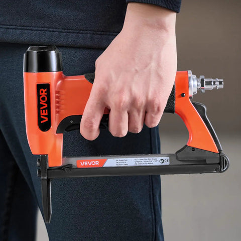 Pro Grade 20 Gauge Pneumatic Staple Gun Featuring A Slick Long Nose, being held in hand, ideal for upholstery and DIY projects.