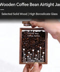 Snag This Wooden Coffee Bean Canister With Airtight One Way Valve That Keeps Your Daily Brew Stash Locked In Crisp And Rich The Straight Kitchen Essential For Any Lazy Weekend Morning Or Office Shelf. Wooden coffee bean jar with glass lid and beans inside.