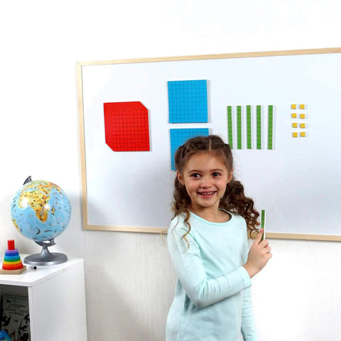 Child using Magnetic Base Ten Blocks For Math, Jumbo 131 Piece Set With Place Value Blocks on a whiteboard in classroom.