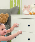 Child interacting with dresser featuring Butterfly And Moon Round Cabinet Knobs 4 Piece Set For Kitchen Cabinets And Drawers Glass And ABS Hardware With Stainless Steel Screws Black Finish Dresser Handle Decor Looks Slick.