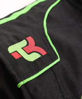 Close-up of black Go Kart Racing One Piece Cordura Suit for Adults XXL with logo and green trim, focusing on stitching detail.