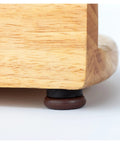 Wooden furniture leg resting on 20 Pieces Brown Plastic Furniture Levelers With Integrated Base For Furniture Legs Cabinets Chairs Tables