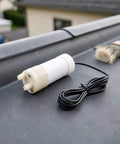 Portable Submersible Sump Pump With Built In Filter And Extended Drain Hose Heavy Duty Water Rig on a surface.