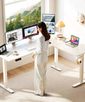 Person using 63 Inch Sit To Stand Electric L Shaped Desk With Height Adjustment Range 27.9 To 46.1 Inches, Reversible Corner Setup