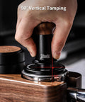Hand using 58mm Espresso Tamper With Ripple Base And Spring Loaded Precision Pressure For Even Extraction on portafilter