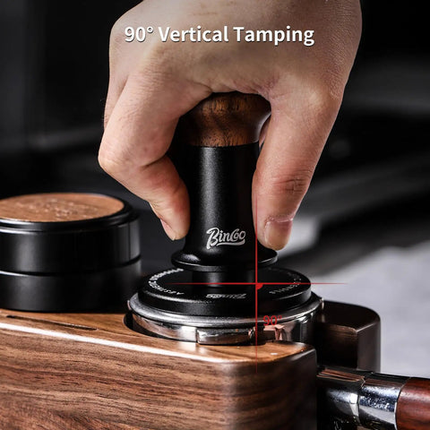 Hand using 58mm Espresso Tamper With Ripple Base And Spring Loaded Precision Pressure For Even Extraction on portafilter