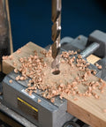 Seven Sixteenth Inch HSS Brad Point Drill Bit for wood delivering clean splinter-free holes in a wooden block on a drill press
