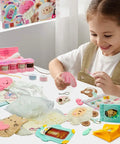 Child using Beginner Sewing Kit For Kids With 9 Different Animal Charms, Easy Pre-Cut Fabric, Plastic Needle Tools on table