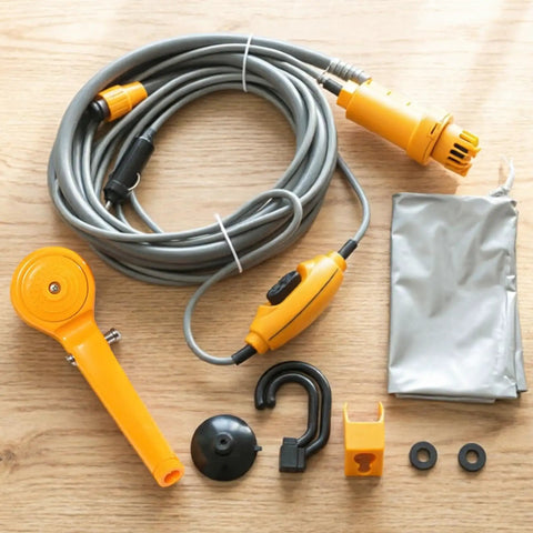 Portable Camping Shower Kit With 12V Pump Steady Water Flow ABS Body components on wooden surface