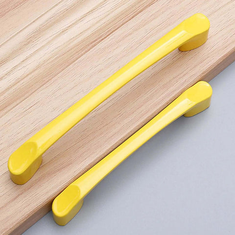 Close up of two 10 Count Ultra Sleek Yellow Square Drawer Pulls And Kitchen Cabinet Handles Hella Tough Aluminum hardware on wood.