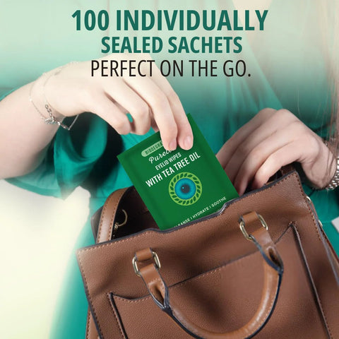 Front view: Purelid eyelid wipes sachet with tea tree oil, green package being placed into a brown handbag
