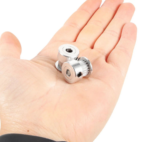Upgrade Your 3D Printer Game with These Solid 20 Tooth GT2 Timing Pulleys Featuring A 5mm Bore For Quick Install And Zero Slippage Plus Heavy Aviation Aluminum Build And Hex Wrench Included For Smooth Performance On Any Machine Setup. 20 tooth GT2 aluminum pulleys in hand, 5mm bore