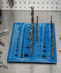 Heavy Duty Stainless Steel Tap And Drill Bit Gauge Laser Engraved Metric And Sae Charts Smooth Blue Pvd Finish on workbench with drill bits.