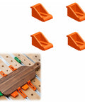 Four orange heavy duty CNC hold down clamps shown on a router table for secure woodwork holding and precision milling.