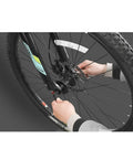 Hands installing 4 Piece Aluminum Bike Axle Quick Release Skewers Set For Front And Rear Wheels on MTB tire