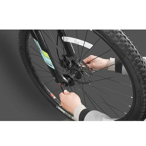 Hands installing 4 Piece Aluminum Bike Axle Quick Release Skewers Set For Front And Rear Wheels on MTB tire