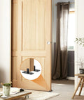 Bottom Mount Barn Door Floor Guide Two Pack T Shape Matte Black Roller Guides for Grooved or Ungrooved Doors installed in room.