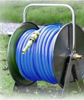 Badass Heavy Duty Stainless Steel Garden Hose Reel With Smooth Crank Handle, blue hose, on stand, outdoor use, neatly stored.
