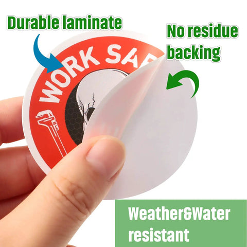 Close-up of a hand peeling a laminated, water-resistant hard hat sticker from a 300-piece Funny Toolbox Decals pack for helmets.