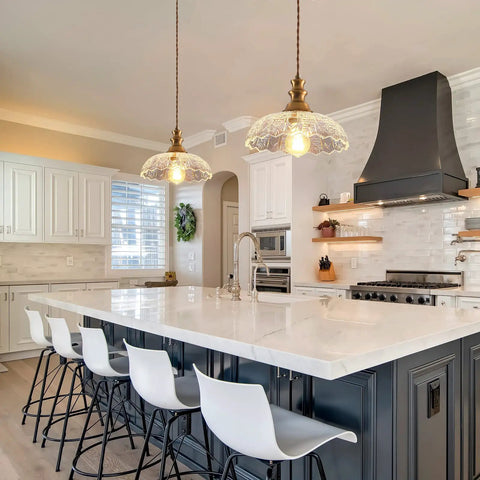 Slick Oil Rubbed Bronze One Light Pendant Ceiling Lamp With Retro Dome Glass Shade above a kitchen island with white bar stools.