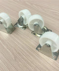Hella Tough Eight Piece Heavy Duty Casters With Secure Locking Brakes And Smooth White Plate Mount Wheels Optimized For Furniture That Glides Like A Charm Today, white rubber wheels and metal mounts.