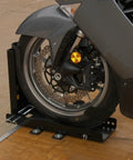 Trailer-Only Bike Chock With Fold-Down Design And Patented Lock For Upright Parking, holding a motorcycle wheel in place