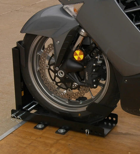 Trailer-Only Bike Chock With Fold-Down Design And Patented Lock For Upright Parking, holding a motorcycle wheel in place