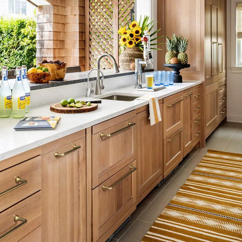 Kitchen with wood cabinets featuring Six Pack Modern Cabinet Pulls in Light Brushed Brass Center to Center Seven and Nine Sixteenths Inches