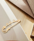 Top Shelf Loop Safety Pin Brooch Set Of Twenty Pieces Electroplated In Rich Golden Tone For Sweaters Coats And Jackets Featuring Reliable Non Slip Clasp, detailed view of one safety pin.