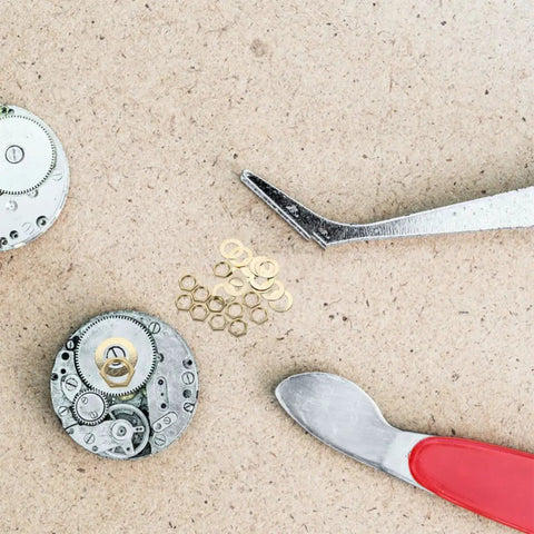 Go-To Clock Washer Set With Nuts And Rubber Rings, 20-Piece Metal Kit For Easy DIY Clock Repair And Mechanism Replacement, Durable Antiaging Materials For Lasting Performance, clock parts on workbench