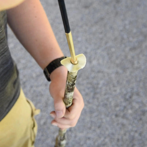 Person using Four Inch Ramrod Extension Jag With 10-32 Threads For Standard.50 Cal Ramrods, brass design visible.