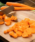 Slicing carrots on Acacia Wood Cutting Board With Feet 17 By 12 Inches Large Rectangle Heavy Duty Prep Board