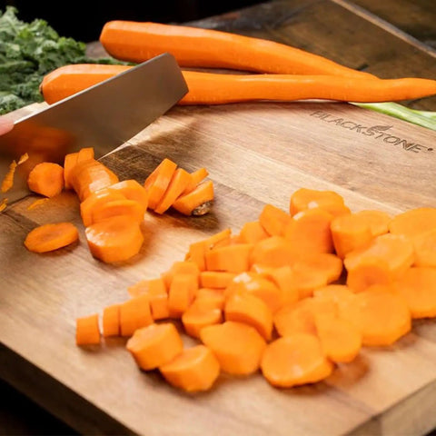 Slicing carrots on Acacia Wood Cutting Board With Feet 17 By 12 Inches Large Rectangle Heavy Duty Prep Board