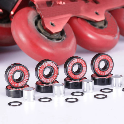 Six ABEC-7 skate bearings with red seals, metal spacers, and black washers; inline skate wheel in background.