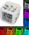 Works Like A Charm Digital Alarm Clock With Spring Blossom Cube Look displaying time and cool room temperature in multiple light colors.