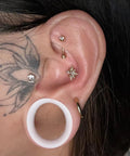 Close-up of ear with 25mm White Silicone Ear Gauges Tunnels Plugs Set For Unisex Piercing With Double Flare Hollow Design in place.