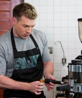 Barista using Two Pack Espresso Distribution Tool Set with Walnut and Rosewood Wood Handle Five Needle Espresso Stirrers