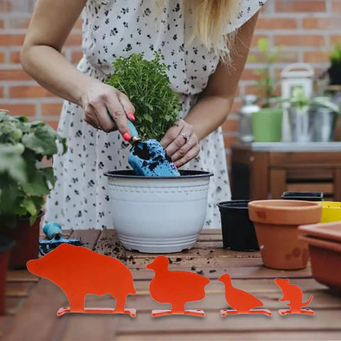 Metal Knockover Animal Target Set For Backyard Shooting Practice, 4 Orange Silhouette Targets on table with potted plants