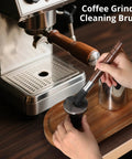 Person cleaning espresso machine with Two Pack Coffee Grinder Cleaning Brush With Natural Walnut Wood Handle And Black Boar Bristle For Grinders