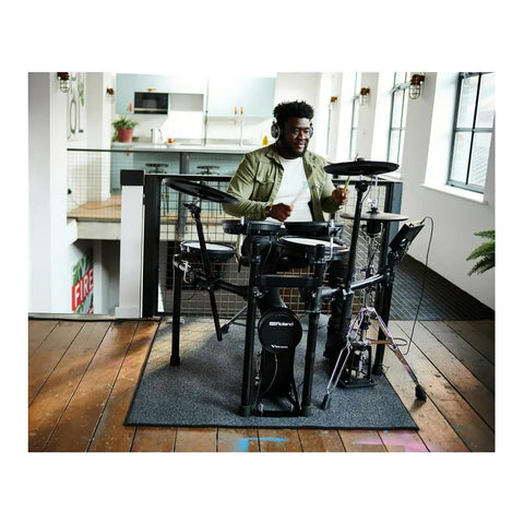 Musician playing Electronic V Drums Kit With Floating Hi Hat And Large Cymbal Pads For Realistic Drumming in a modern room