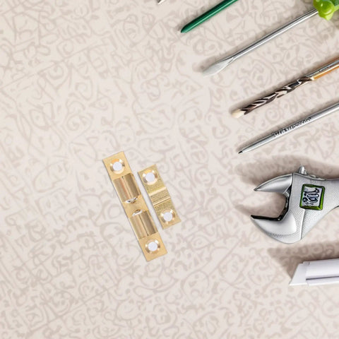 Brass Door Catch Hardware Set With Adjustable Spring Ball Latch for cabinets and closets, shown with various tools on a table.