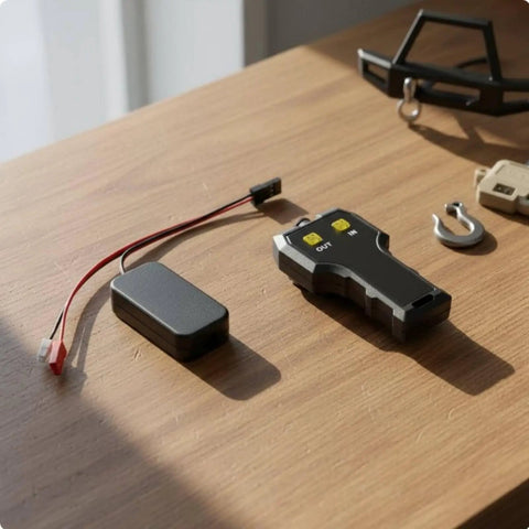 Ultimate 1/10 Scale Rc Crawler Electric Winch With Metal Brackets And Nifty Wiring Setup For Realistic Recovery Simulations Indoor Testing Fun remote control and wiring components on a wooden surface