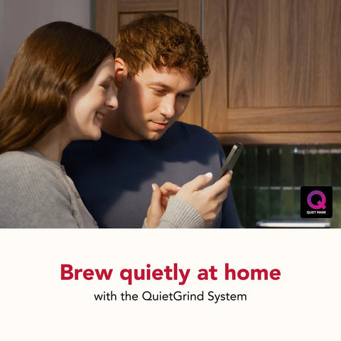 Couple enjoying coffee routine next to Compact Fully Automatic Espresso And Iced Coffee Maker With One Touch Brewing.