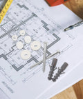 Toilet Tank Bolts And Gasket Kit Replacement Screws Set For Easy Install No Fuss Durable Toilet Hardware With Gasket Seals The Ultimate Toilet Repair Kit For Seats Tanks And Covers. Brass bolts and white gaskets on blueprint
