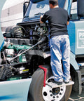 Man using Heavy Duty Tire Step For Trucks And SUVs, 300 Lb Capacity, Non Slip Cheese Grater Steel Surface to reach engine bay.