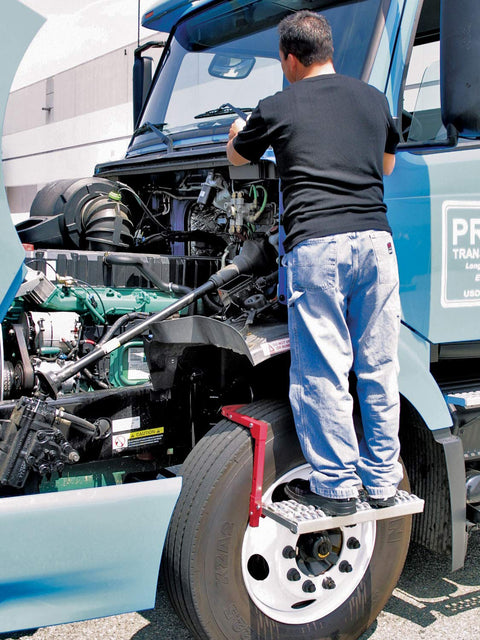 Man using Heavy Duty Tire Step For Trucks And SUVs, 300 Lb Capacity, Non Slip Cheese Grater Steel Surface to reach engine bay.