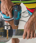 Person using power drill with Cobalt Drill Bit Set For Hardened Metals Stainless Steel Cast Iron And Wood Plastics, 29 Pc M35 HSS Twist Bits With Metal Index Box, Range From One Sixteenth To One Half Inch, 135 Degree Split Point For Easy Starts And Beast Longevity.
